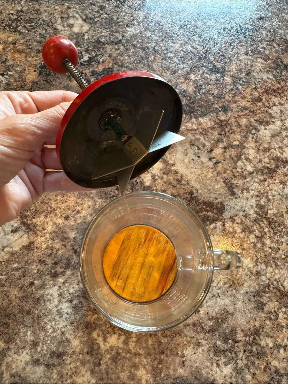 Vintage Hazel Atlas glass kitchen chopper with red lid and ball handle